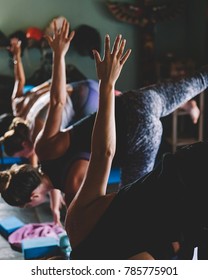Sweating People Practicing Yoga During Retreat In Studio