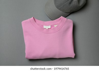 Sweatshirt and cap on gray background, space for text - Shutterstock ID 1979414765