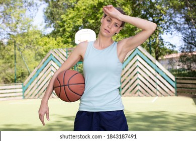 Sweaty Female Basketball Player Wiping Her Brow