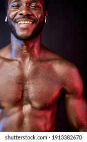 Sweaty Sportsman In Headphones Isolated On Black Background, Shirtless Guy After Sport Exercises Workout