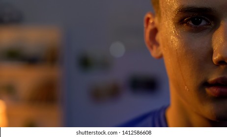 Sweaty Teenager Looking To Camera After Intensive Workout In Gym, Serious Face