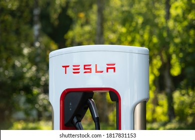 Kungälv - Sweden. Circa September,2020: Tesla supercharger and logo in focus. Diffuse background.