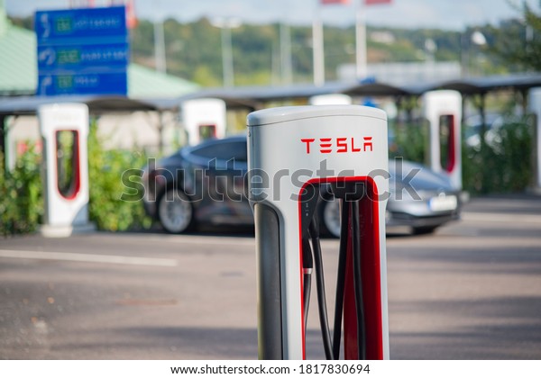 Kungälv - Sweden. Circa\
September,2020: Tesla supercharger and logo in focus. Diffuse\
background.