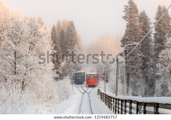 Åre, Sweden - Dec 14, 2018: Two trolleys to\
the mountain railroad in Åre, Sweden, opened 1908 as the first\
permanent connection up to the\
mountain.