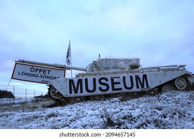 Strängnäs, Sweden. December 05, 2021. Arsenalen museum. White tank camouflaged in the snow. Flag and information about the Swedish fordonsmuseum.