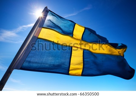 Sweden flag on dark blue sky background.