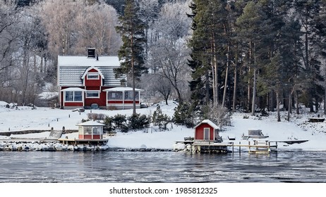 Sweden House In The Wintertime. Nature On The Shore Of The Fjord.