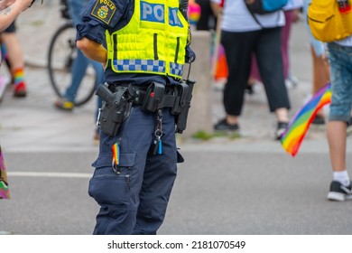 Malmö, Sweden - July 09 2022: Swedish Police Equipped With A Service Weapon, Mace, Baton And A Rainbow Coloured Key Chain.