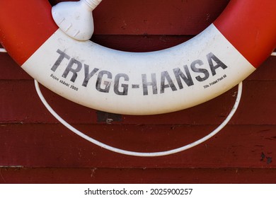 Alingsås, Sweden - July 24 2021: Red And White Lifesaver Bouy On A Wall.