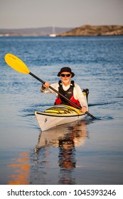 Bohuslän, Sweden July 3 2015. A Middle Aged Man Exploring The Swedish Archipelago By Sea Kayak, Bohuslän, Sweden