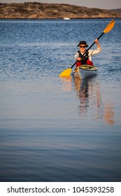 Bohuslän, Sweden July 3 2015. A Middle Aged Man Exploring The Swedish Archipelago By Sea Kayak, Bohuslän, Sweden