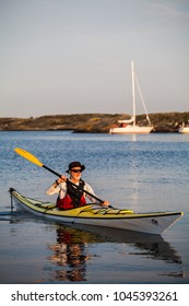 Bohuslän, Sweden July 3 2015. A Middle Aged Man Exploring The Swedish Archipelago By Sea Kayak, Bohuslän, Sweden