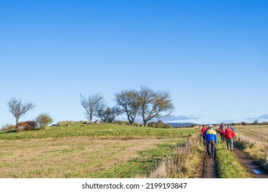 Falköping, Sweden, October, 2020, Group With Older People Walking On A Dirt Road By A Field