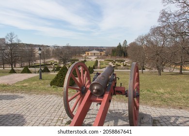 Sweden, Uppsala - April 19 2019: the view from a hill on a cannon of the Uppsala Castle Bastion and The Uppsala Botanical Garden University building on April 19 2019 in Uppsala, Sweden.