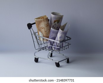 swedish banknotes in a shopping cart on white background