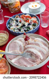 Swedish Christmas Table With Festive Food. Ham Eggs And Salmon Visible
