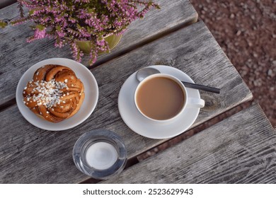 Swedish fika. Swedish cinnamon bun and coffee on a wooden table  - Powered by Shutterstock