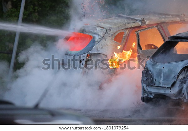 Swedish fire brigade that extinguishes a major car\
fire where 18 cars were set on fire during the night. Pictures\
taken May 27