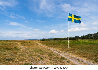 Swedish flag waving in wind with beautiful sky.