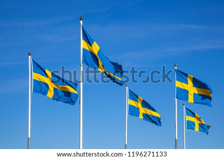 Swedish flags on the national day against a blue sky