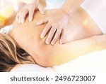 Swedish massage session for woman lying at massage table at massage room