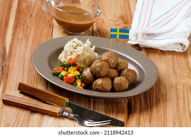Swedish Meatball with Mushroom Brown Sauce and Boiled Vegetable, Served with Creamy Mashed Potato. On Wooden Table