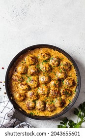 Swedish Meatballs In A Creamy Sauce In A Black Frying Pan, Gray Background, Top View. Scandinavian Food Concept.