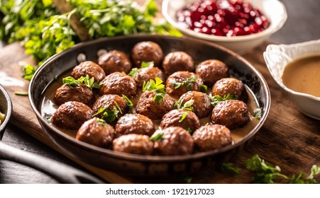 Swedish meatballs, kottbullar, in a pan topped with fresh parsley.