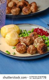 Swedish meatballs with potatoes on blue wooden table
