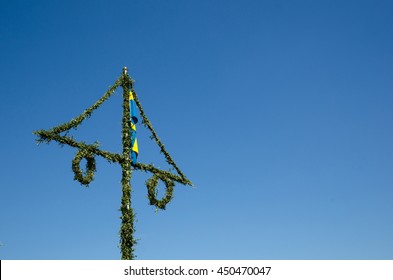 Swedish Midsummer Pole At A Cloud Free Blue Sky