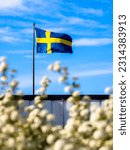Swedish national flag waving on the island of Vrango, Gothenburg, Sweden