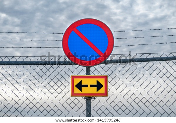 Swedish\
no parking sign with a cloudy sky as\
background