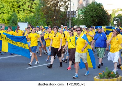 Swedish Soccer Fans In Yellow Color T-shirts And With National Flags Marching On The Street Supporting Their Football Team. Euro-2012, Swedish Camp. July 1, 2012. Kiev, Ukraine