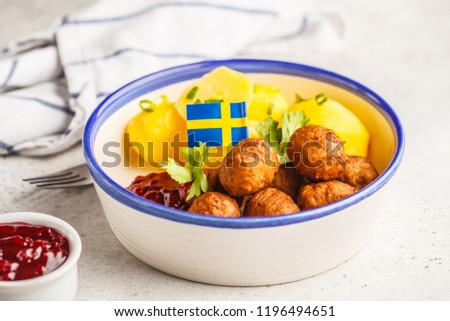 Swedish traditional meatballs with boiled potatoes and cranberry sauce. Swedish food concept.