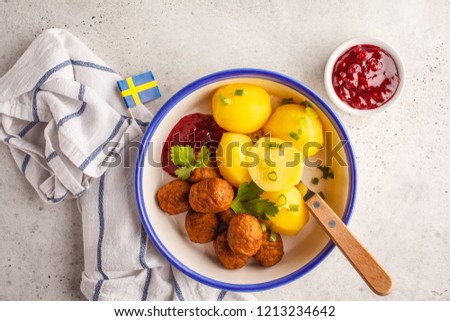 Swedish traditional meatballs with boiled potatoes and cranberry sauce. Swedish food concept.