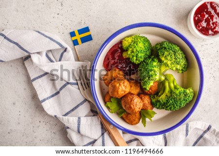 Swedish traditional meatballs with broccoliand cranberry sauce. Swedish food concept.