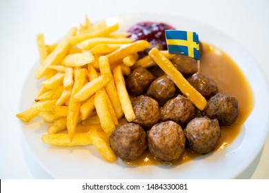 Swedish traditional meatballs with fried potatoes and cranberry sauce. Swedish food concept.