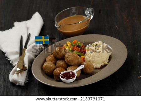 Swedish Traditional Meatballs with Mashed Potatoes and Cranberry Sauce. Swedish Food Concept. On Wooden table