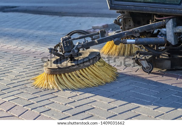 Sweeper\
cleaning machine in the streets. Close\
up.