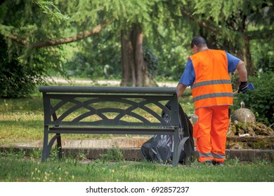 Sweeper Cleaning The Park, Man With Hi Vis Safety Vest Collects Garbage