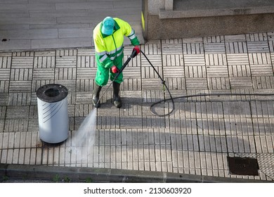 Sweeper cleaning a street sidewalk with high pressure water jet machine  Street maintenance