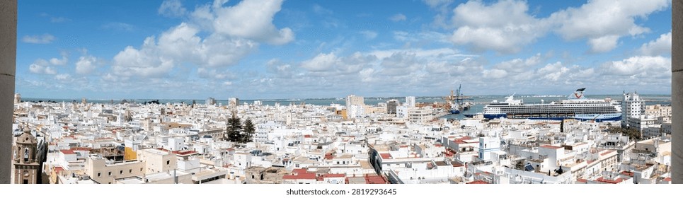 A sweeping panorama captures the white rooftops of Cádiz, Spain, from the cathedral tower vantage point.