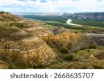 A sweeping panoramic view from the River Bend Overlook Trail in Theodore Roosevelt National Park captures the majestic Missouri vista