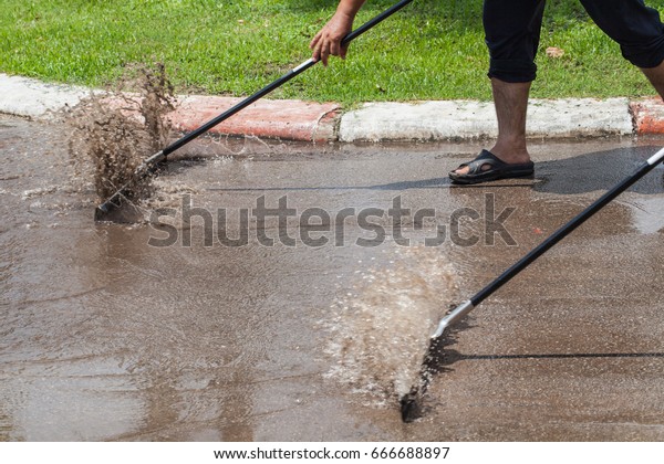 Sweeping water on the\
streets