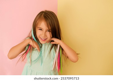 A sweet adorable girl adjusts her dyed bright colored hair. Artificial Hair Extensions - Powered by Shutterstock