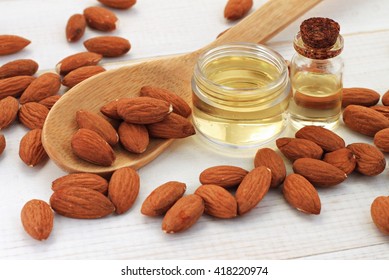 Sweet Almond Oil In Bottles, Almond Kernels Scattered.