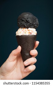 Sweet Ash (activated Charcoal) And Fruity Pebble Ice Cream In A Chocolate Cookie Cone