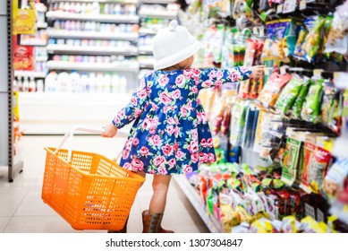 Sweet Asian Girl Shopping In Mini Mart With Basket, Enjoy Buying Thing In Mart