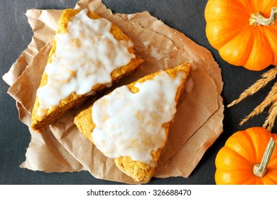 Sweet Autumn Pumpkin Scones With Frosting, Overhead View On Dark Slate Background