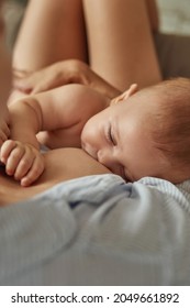 Sweet Baby Falling Asleep In Mother's Hands. Unrecognisable Woman Breastfeeding Naked Baby To Give Him Skin Contact And To Put To Sleep. Top View.